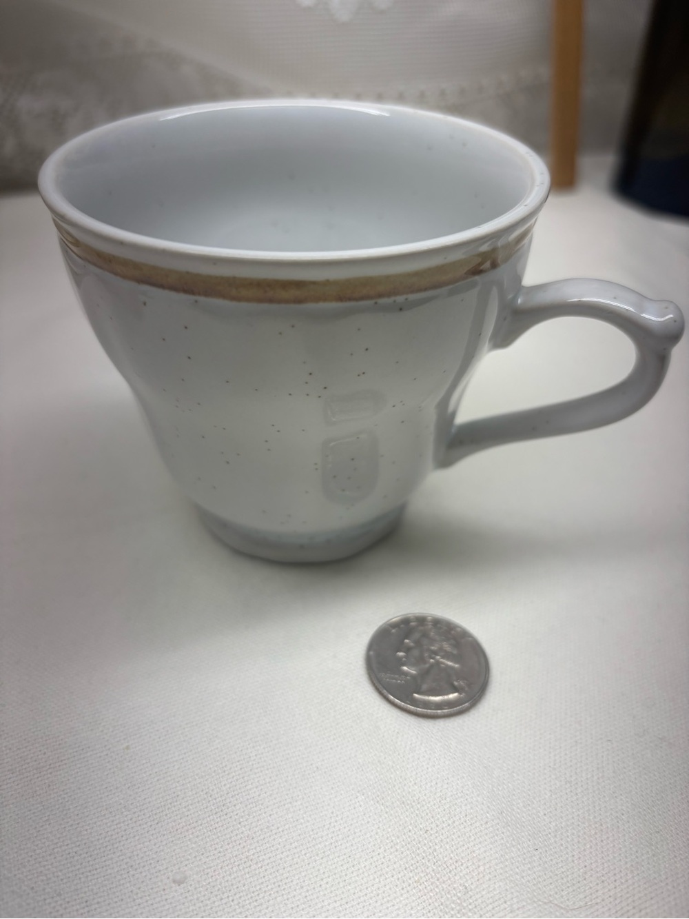 Speckled White Ceramic Teacup with Gold Rim
